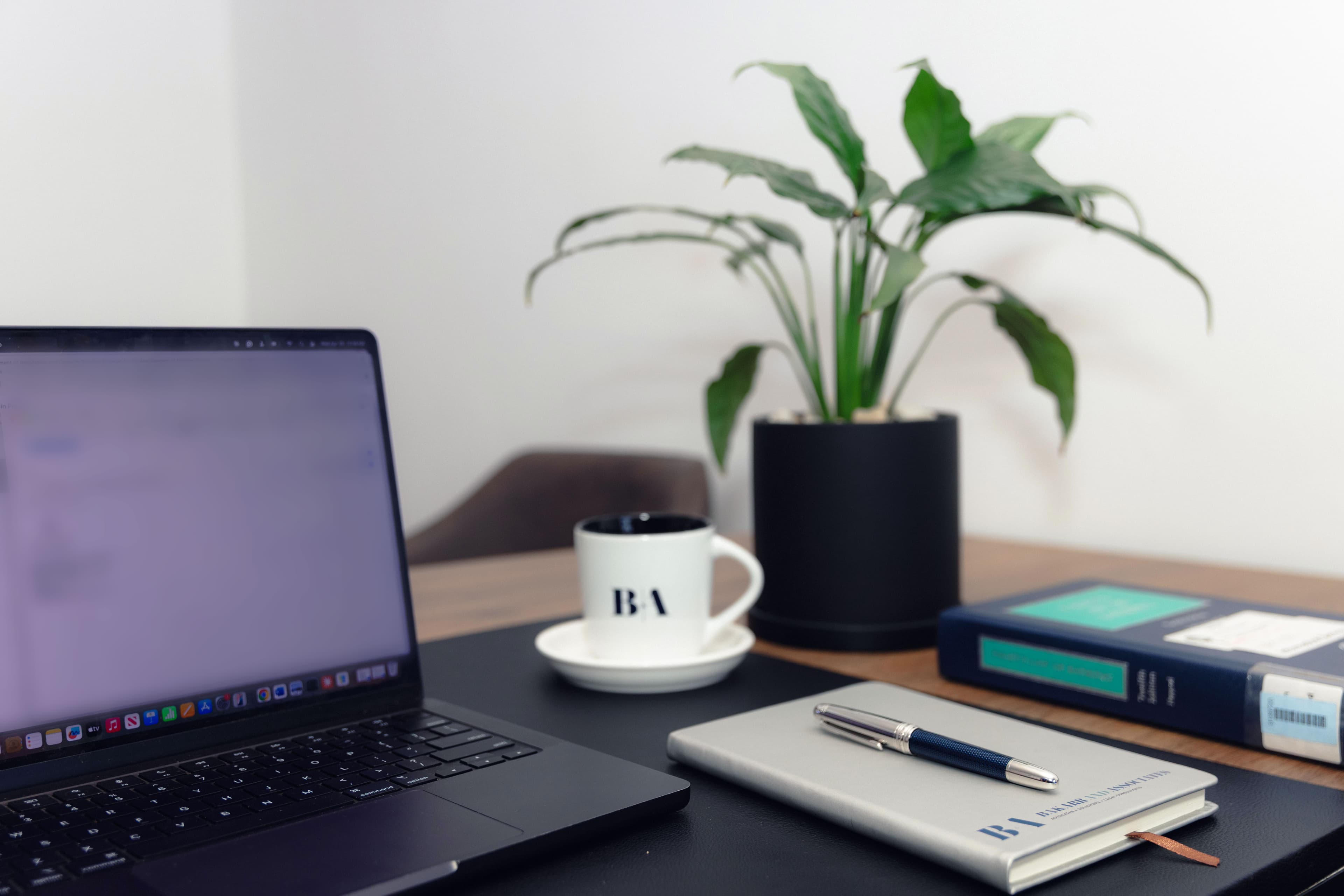Workspace detail with branded coffee cup and plant