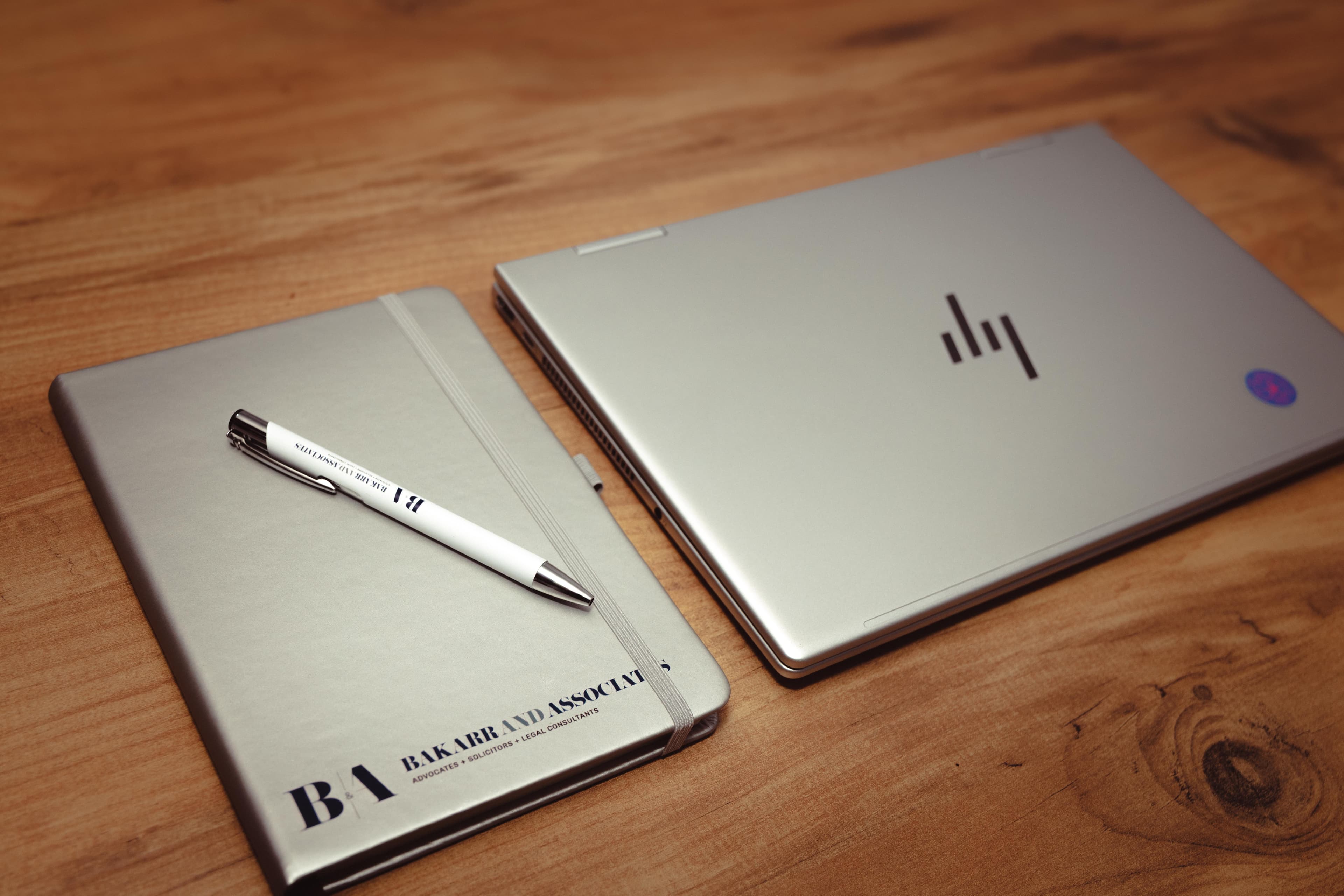 Bakarr & Associates branded notebook and laptop