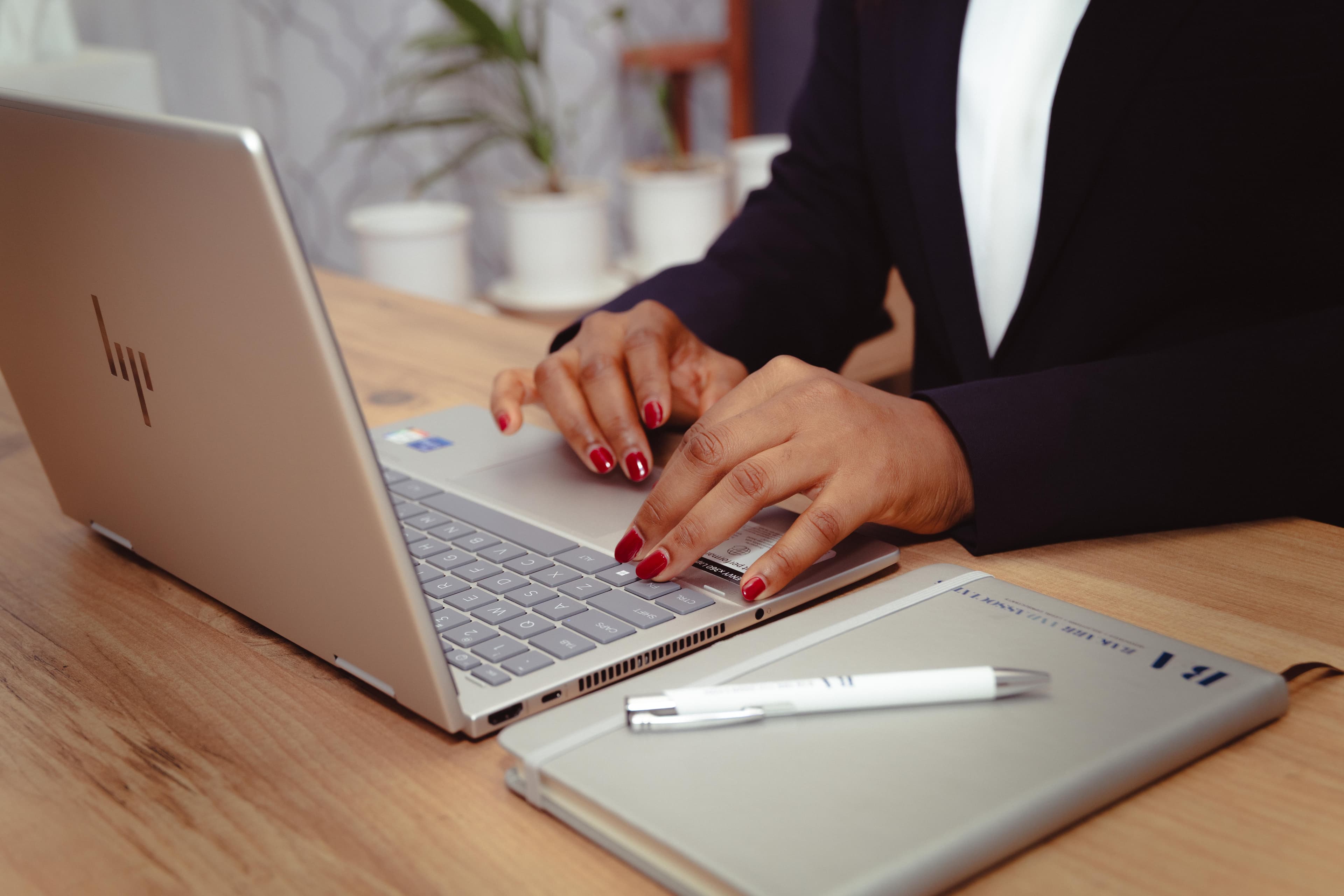 Lawyer working at her desk, hands on laptop