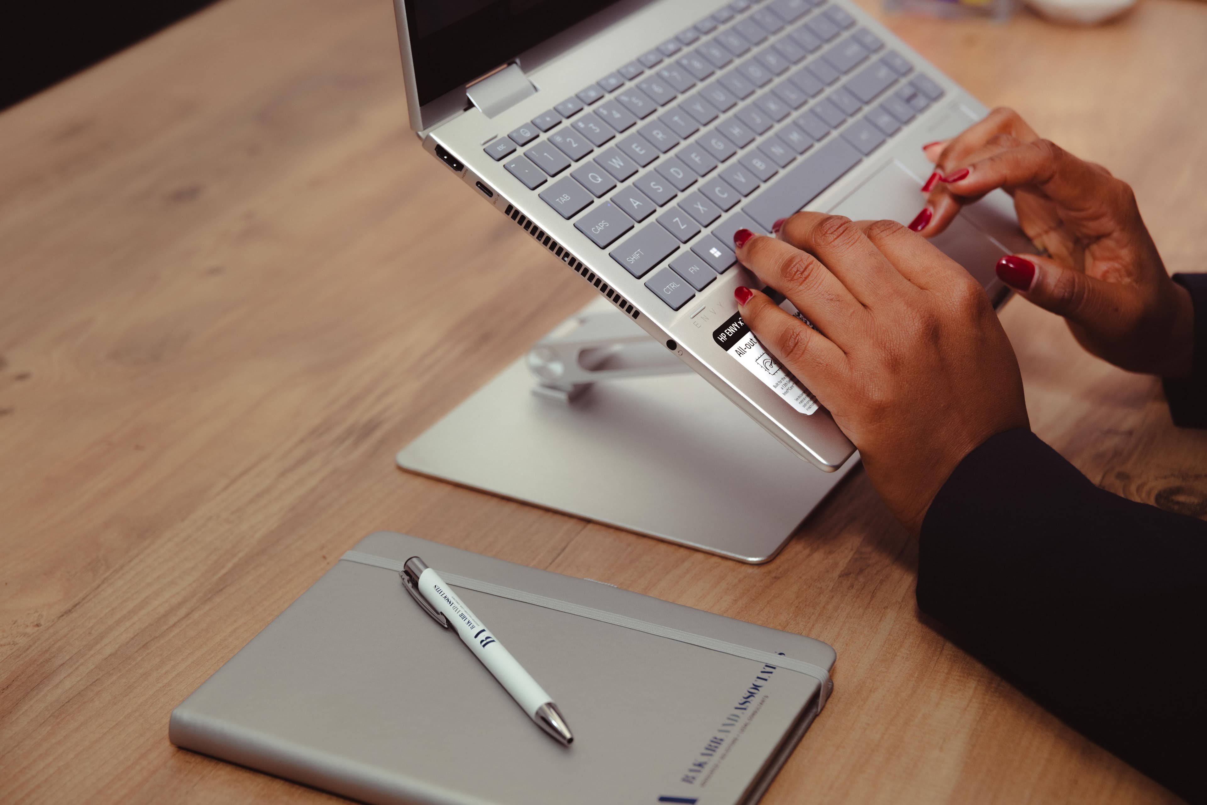 Hands typing on a laptop at the firm
